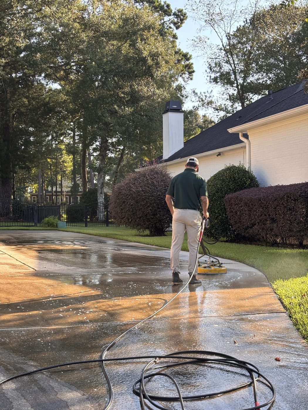 Pressure washing driveway dirty-to-clean line in Spanish Fort, AL