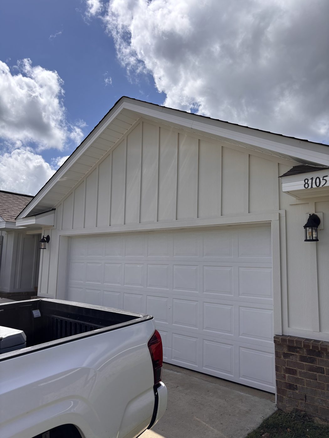 Clean white garage and siding after soft washing in Daphne, AL