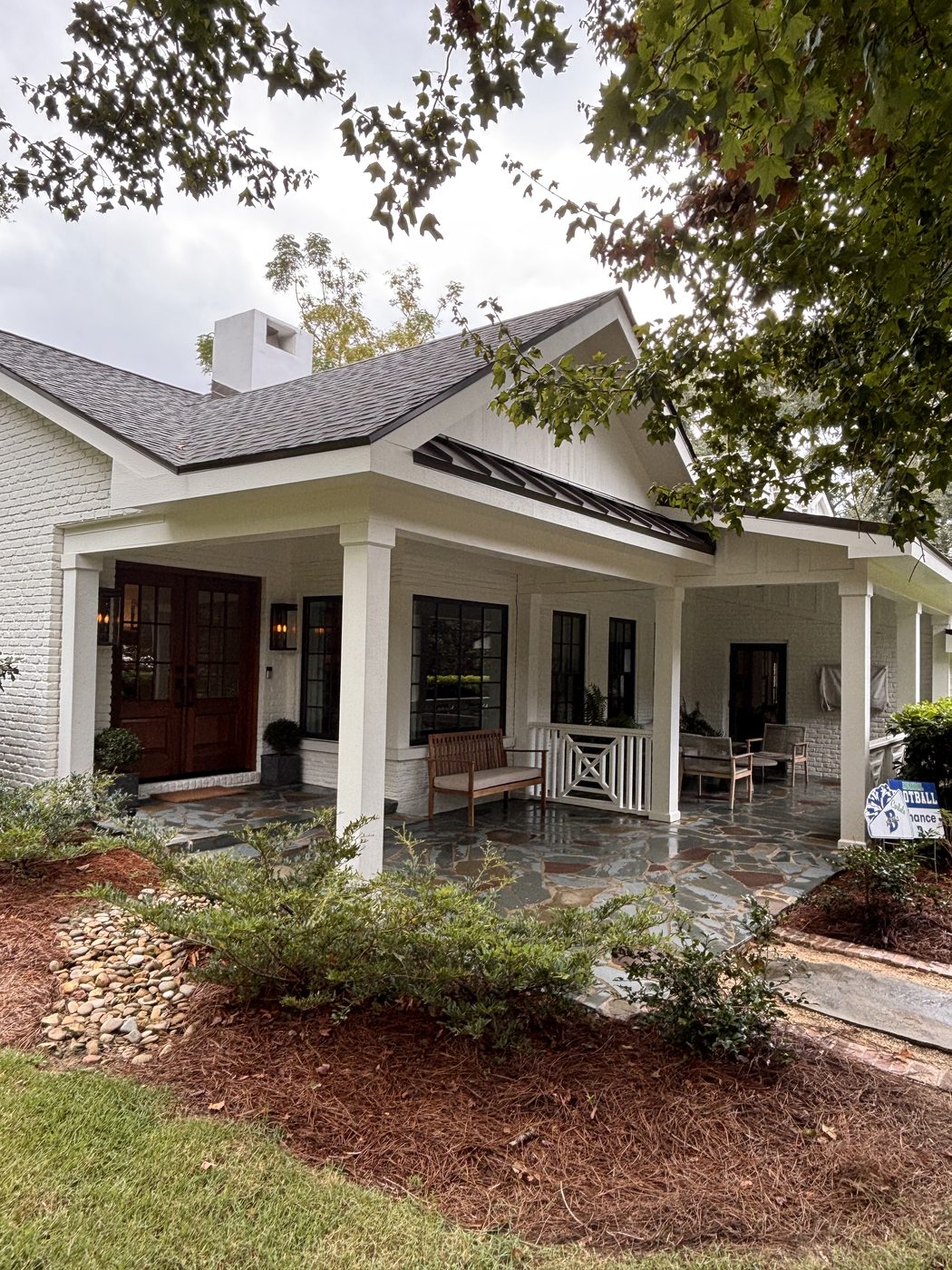 Clean flagstone porch and white brick entry after house wash in Fairhope, AL