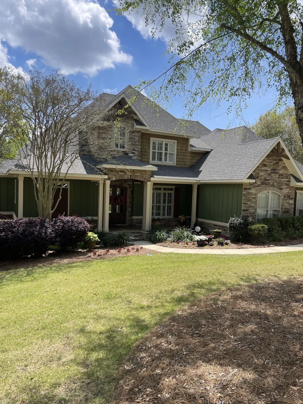 After: exterior windows cleaned on the rear of a brick and siding home with porches in Spanish Fort, AL