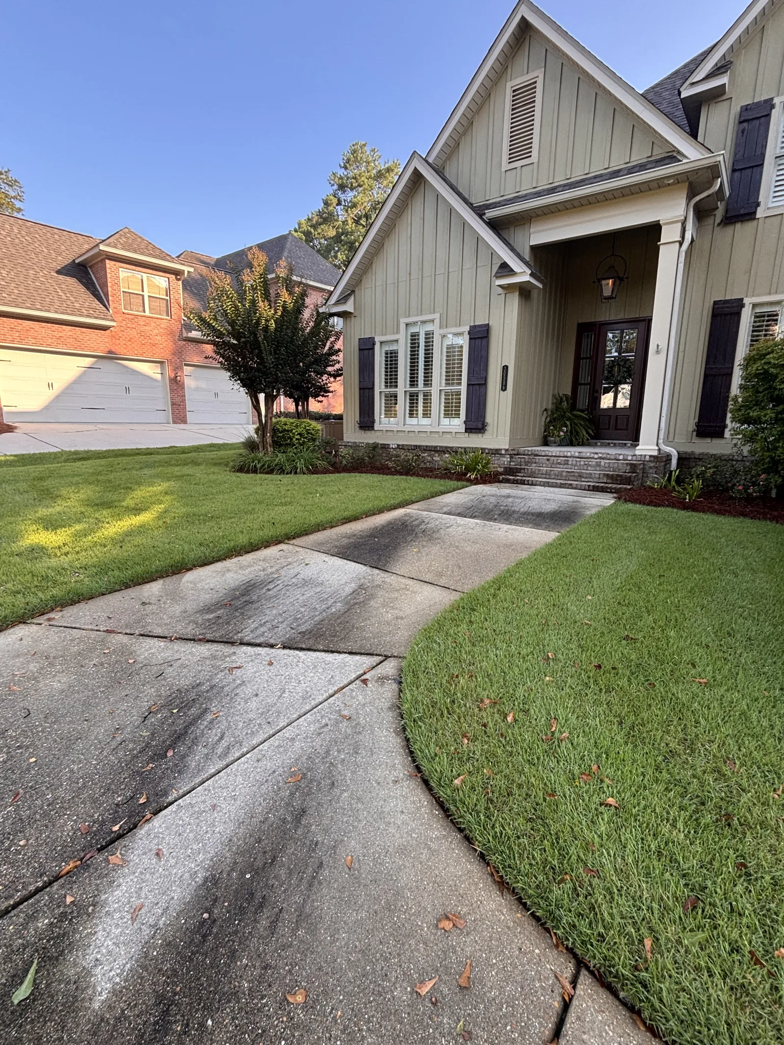 Before: stained concrete driveway under oaks in Spanish Fort, AL